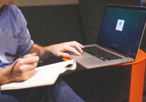 An Excel Consultant custom making a program on his laptop.