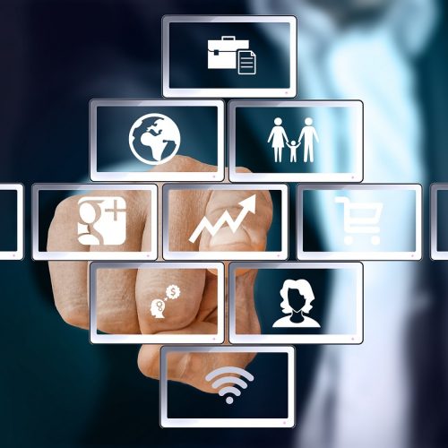 A businessman touching with his finger the screen of his new custom made Marketing Automation Software for Small Business.